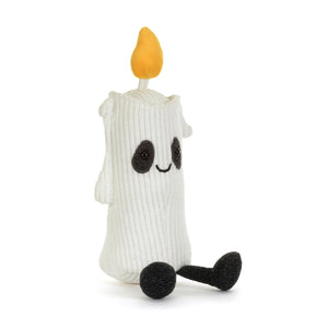 A white corduroy candle plush toy with a yellow-orange flame on top. It has a black mouth and eyes, black sparkly patches around it's eyes and black feet. It is shown on a white background. 