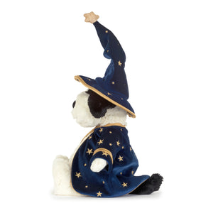 Side view of a plush black and white dog toy dressed as a wizard, featuring a navy blue velvet robe and pointed hat with gold star patterns and trim, set against a plain white background.