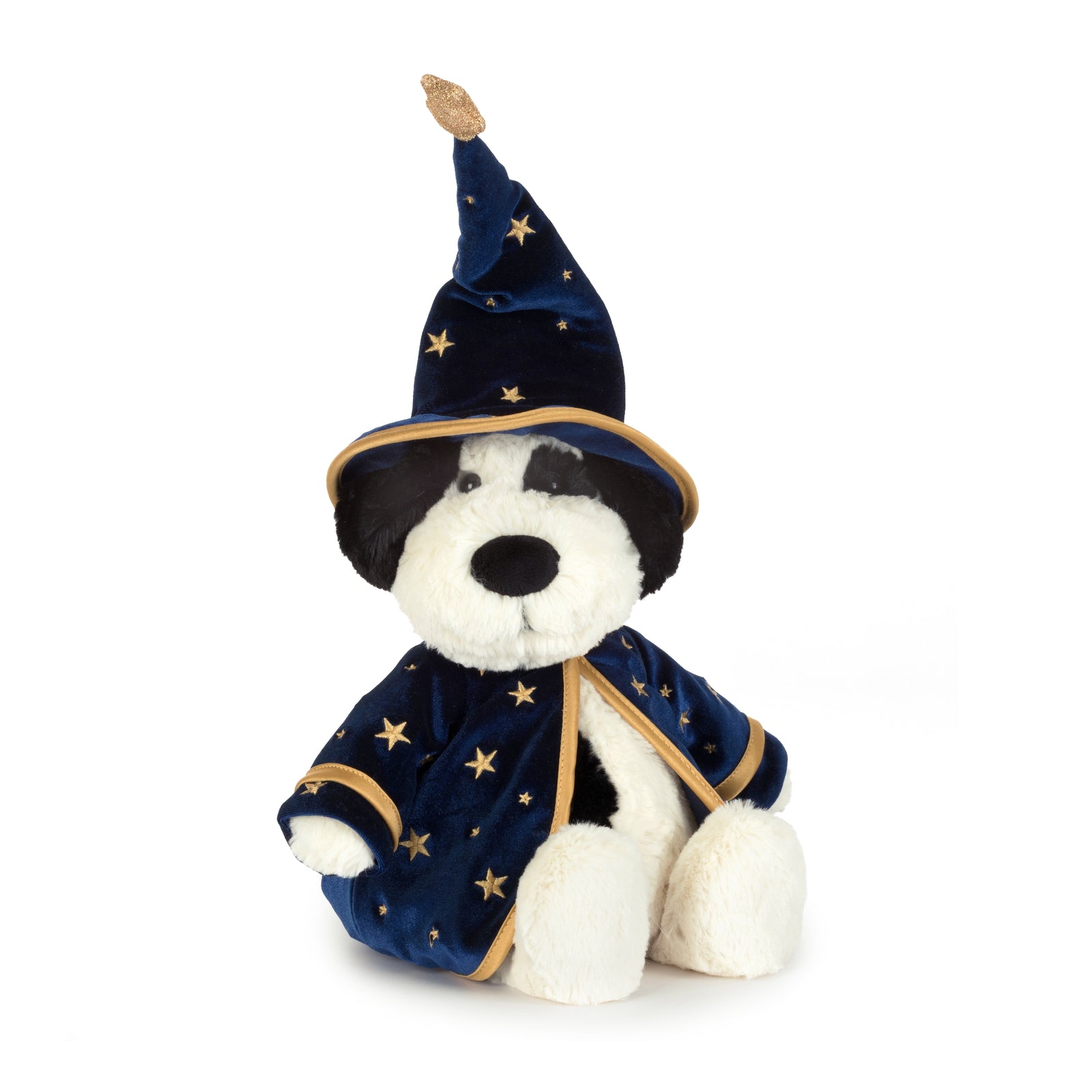 A plush black and white dog toy dressed as a wizard, featuring a navy blue velvet robe and pointed hat with gold star patterns and trim, set against a plain white background.
