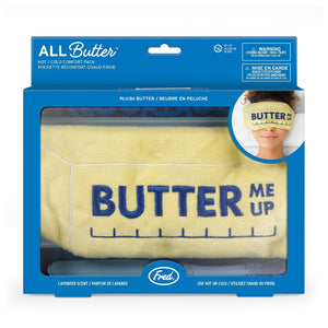 A yellow comfort eye mask in the shape of a stick of butter shown in its blue packaging box, with the company branding and the text 'All Butter'. An image of a woman wearing the mask over her eyes is pictured in the top right corner. The product is shown on a white background. 