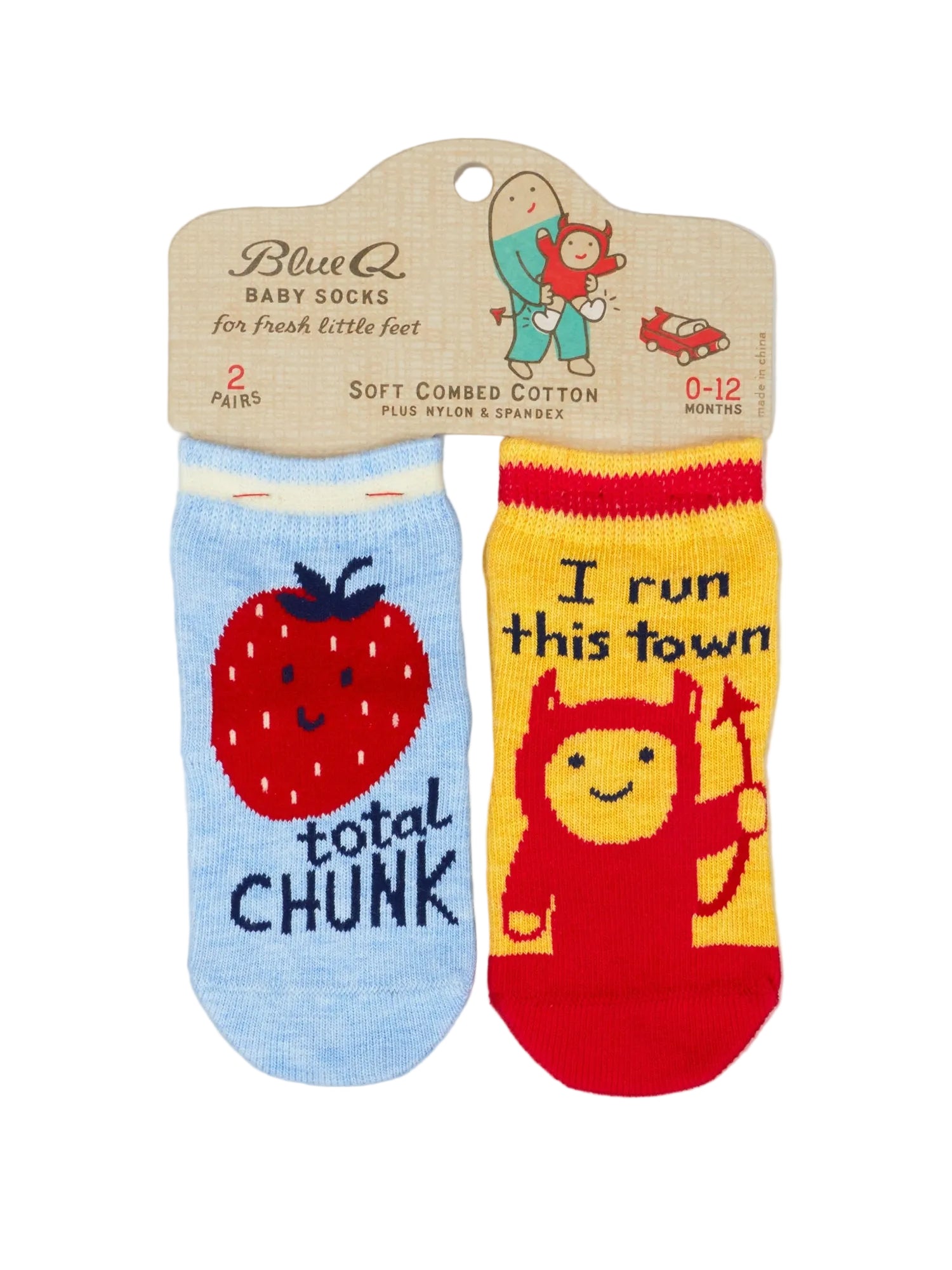 A pair of Blue Q baby socks on their original cardboard hanger. One sock is light blue with a red strawberry and the text 'total chunk', and the other is yellow with a red devil character and the text 'I run this town'. The socks are shown on a white background. 