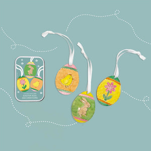 Set of Easter themed decorations with images of a flower, a bunny and a chicken on a light blue background.