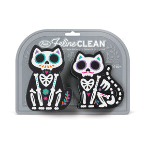 Image of two sugar skull cat-themed kitchen sponges attached to their packaging. The packaging is grey with the text 'Feline Clean' and the company branding and sits on a white background.
