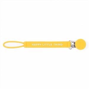 bella tunno bright yellow pacifier clip. a band with the text "happy little thing" have a loop on one end and a clip on the other. 