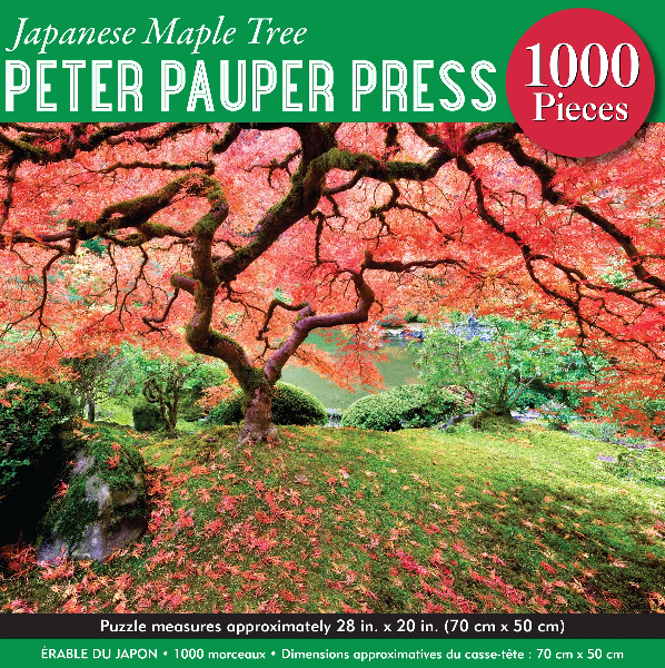 green puzzle box with top text that reads "japanese maple tree peter pauper press 1000 pieces". an image of colourful maple tree in a landscape is pictured between green banners