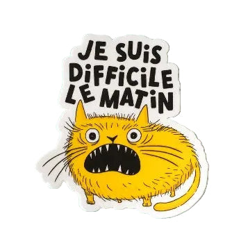 A vinyl sticker featuring an illustration of an angry yellow cat with the French text 'Je suis difficile le matin' in black lettering. The sticker is shown on a white background. 