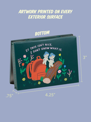 Back view image of a dark green pocket-sized storage tin featuring an illustration of a two smiling mushrooms climbing out of a red backpack and stepping onto a log as they hold hands. They are surrounded by colourful flowers. The text 'If this isn't nice, I don't know what is' is printed over the images. The tin sits on a blue background, beside the product dimensions. 