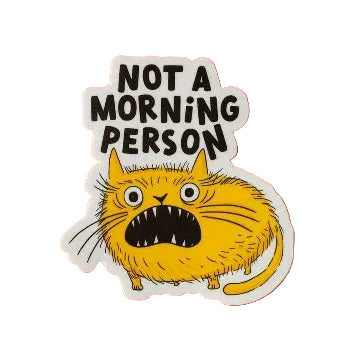 A vinyl sticker featuring an illustration of an angry yellow cat with the French text 'Not a morning person' in black lettering. The sticker is shown on a white background. 
