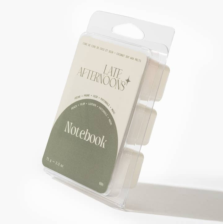 A packaged wax melt product with a label that shows the brand name and the text 'Notebook' with a light and dark green colour scheme. The package sits on a white background.