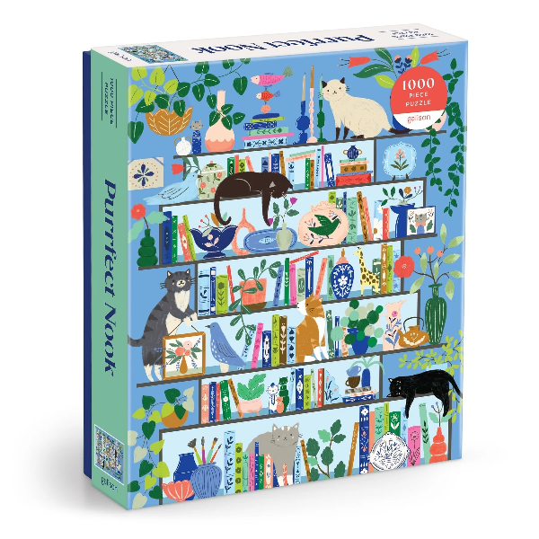 Puzzle box with a blue background and various illustrations including a cat, a bird, and books, indicating a cozy nook theme.