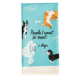 Image of a blue folded kitchen cloth with playful dog illustrtions and the text 'People I Want To Meet: 1. Dogs'.