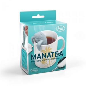 Image of a packaging box for a manatee-themed tea infuser. The box shows an image of the tea infuser hanging inside a white mug filled with tea on a blue background. The text 'Manatea' and 'everyone's favourite Floridian' is printed on the box along with the company branding. 
