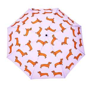 Open view of a purple umbrella with an abstract weiner design on a white background. 