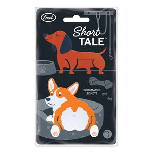 Image of two dog-shaped bookmarks in the shape of an orange and white corgi and a brown and black dachschund. The bookmarks are shown attached to the product packaging, on a white background. The text 'Short Tale' and the company branding are shown at the top of the packaging. 