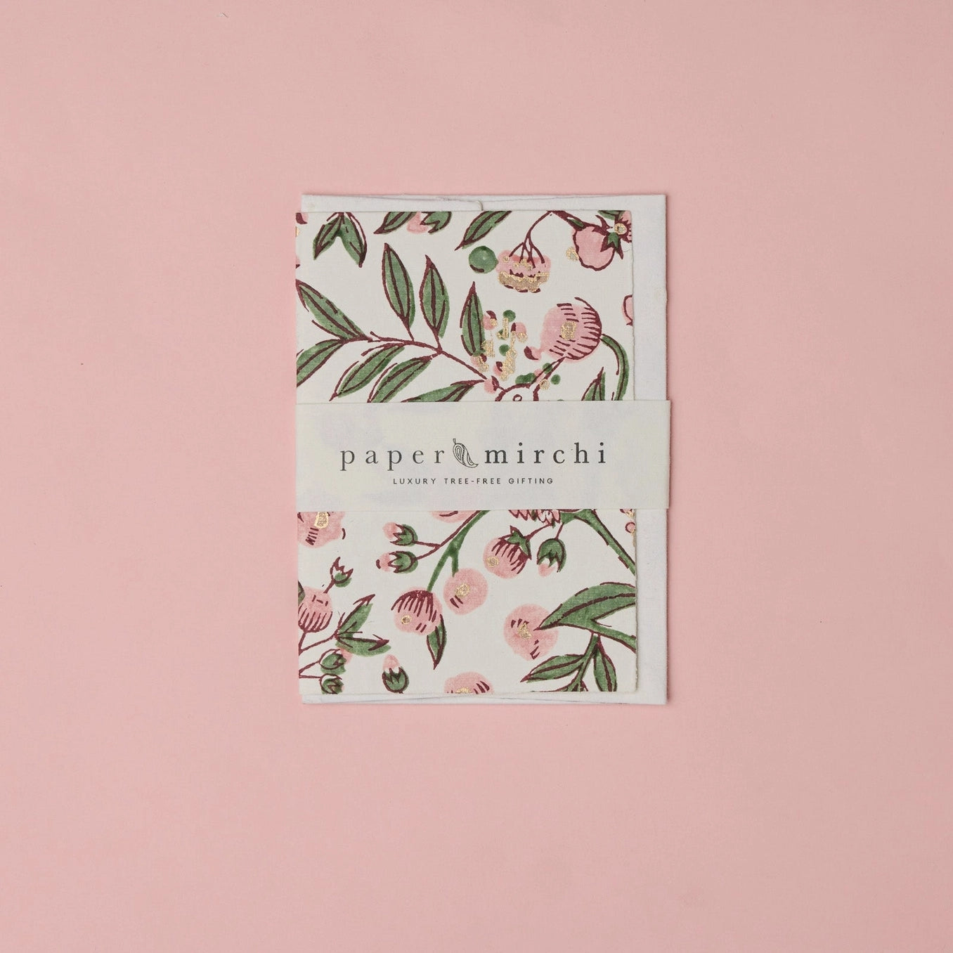 Cotton paper greeting card with a pink, green and gold botanical design on a pink background. 