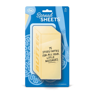 Image of a pack of sticky notes in the shape of a yellow bar of butter in blue packaging. The text 'Spread Sheets' is printed at the top of the packaging along with the company branding. A sticker on the front of the sticky notes says '75 sticky notes for all your little messages'.