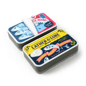 Image of two kitchen sponges that are designed to look like cans of sardines on a white background.