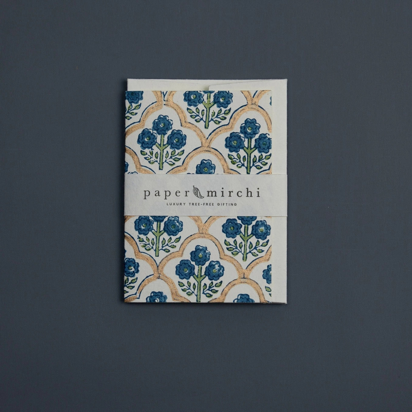 Cotton paper greeting card with a blue, green and gold botanical design on a blue background. 