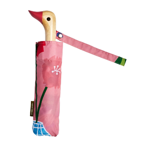 Pink umbrella with an abstract plant and vase design and a wooden duck head shaped handle on a white background. 