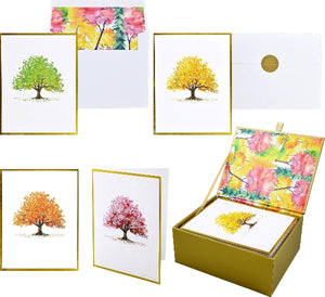 Set of greeting cards with tree designs in a gold box with a tree print interior. 