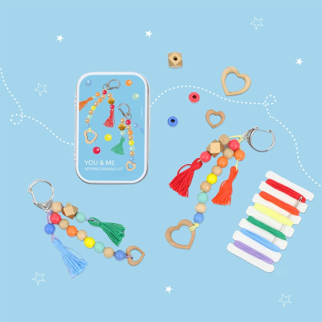 Colorful keychains, decorative beads and colourful threads on a blue background with 'YOU & ME' branding.