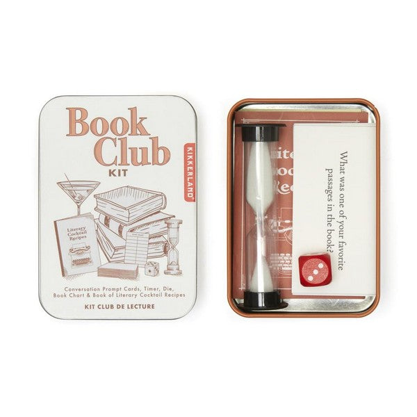 open metal container. the lid is off-white with an illustration of a pile of books, a martini, a die, and more. top text reads "book club kit". opened container reveals a timer, a red die, prompt cards, and more. kikkerland product on white background.