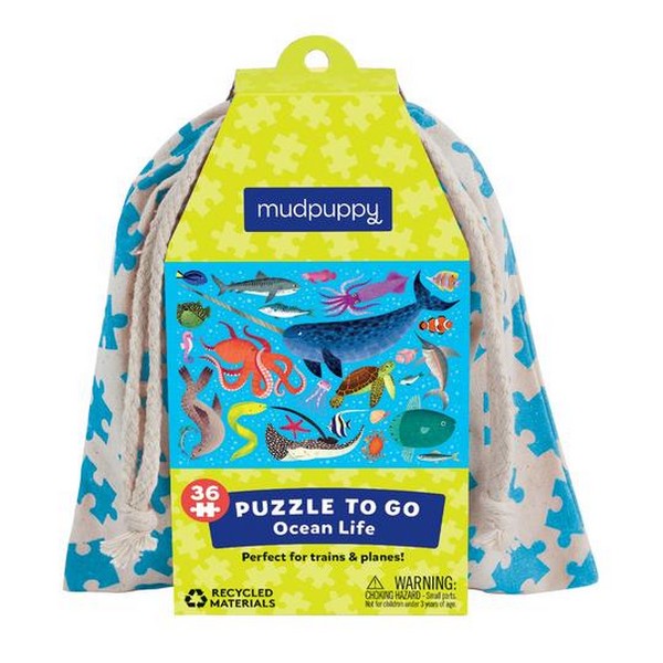 Puzzle packaging with illustrations of an ocean scene with ocean creatures and a drawstring bag. 