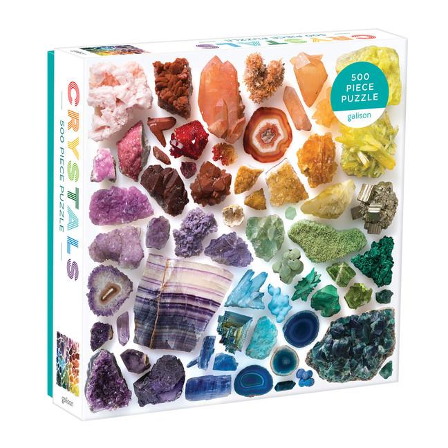 white puzzle box. the cover shows a rainbow of assorted crystals and gems